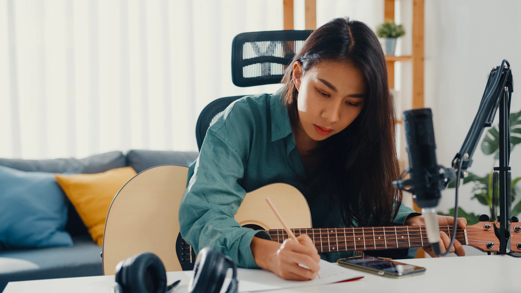 happy asian woman songwriter playing acoustic guitar and listen song from smartphone 7861 2939