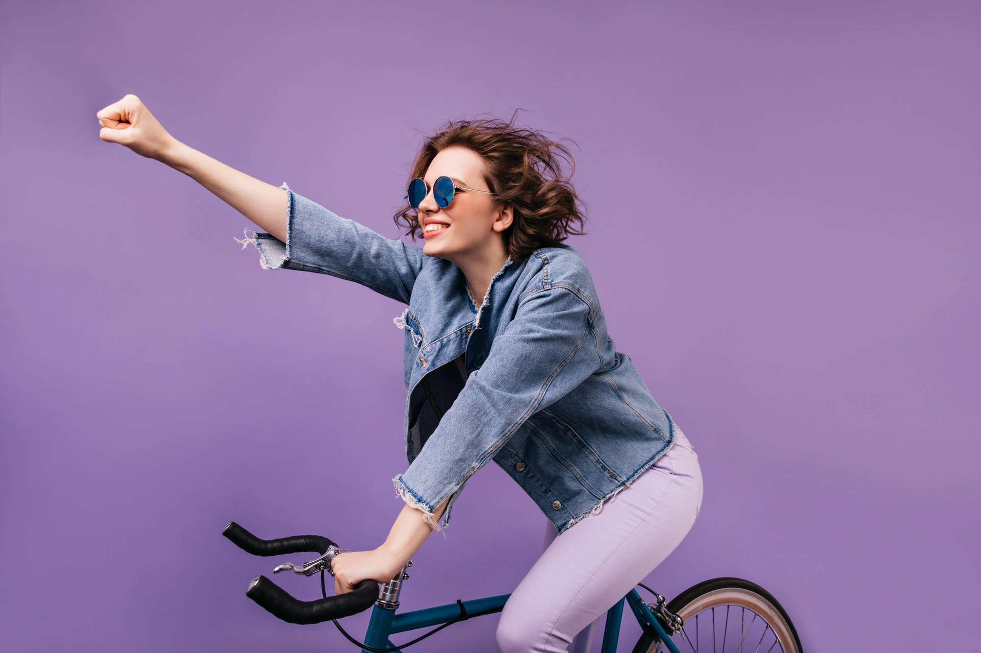 confident girl in denim jacket riding on bike and waving hand indoor photo of inspired young lady in glasses sitting on bicycle 197531 20552