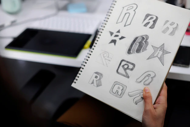 hand holding notebook with drew brand logo creative design ideas 53876 13985