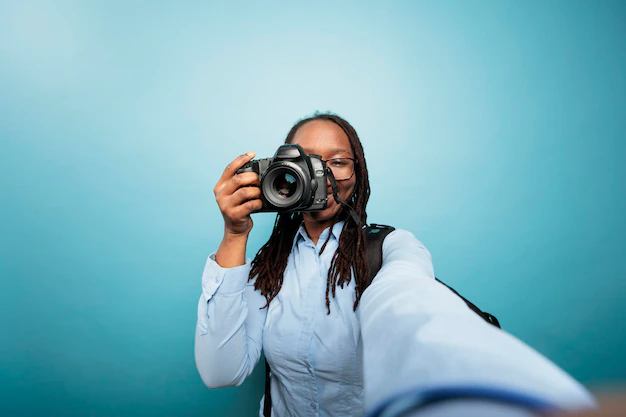 creative amateur photographer taking pictures with modern camera social media young adult african american woman pointing dslr device camera while taking photo blue background 482257 44691