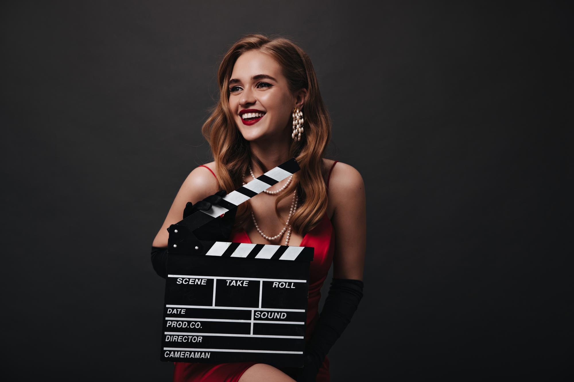 lady with red lips holding clapperboard black background happy woman luxury silk dress smiling posing isolated backdrop 197531 29121