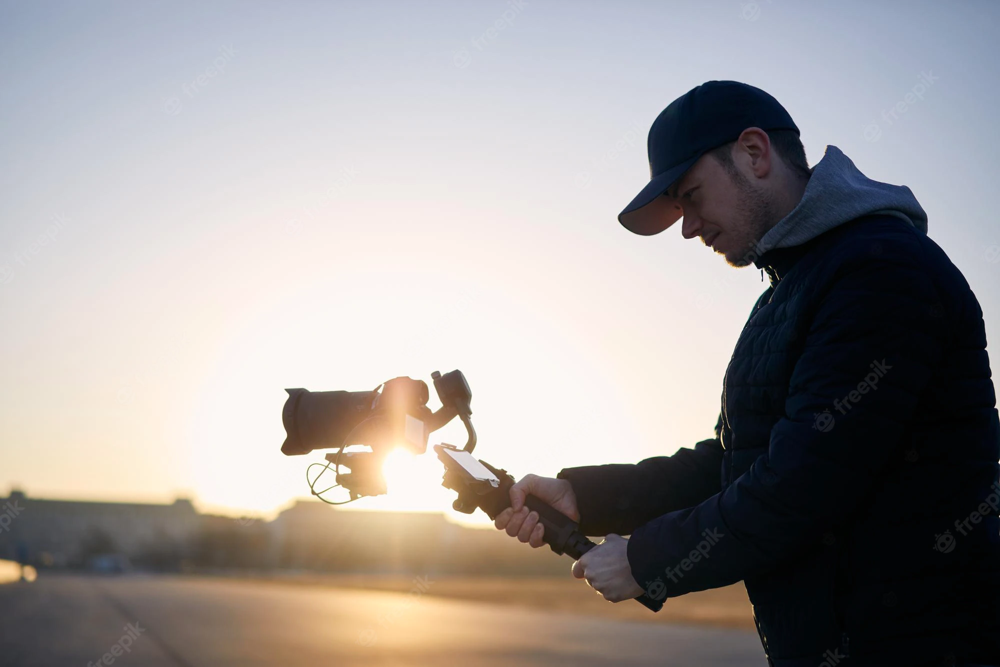 man filming with camera gimbal against city sunrise 697241 662