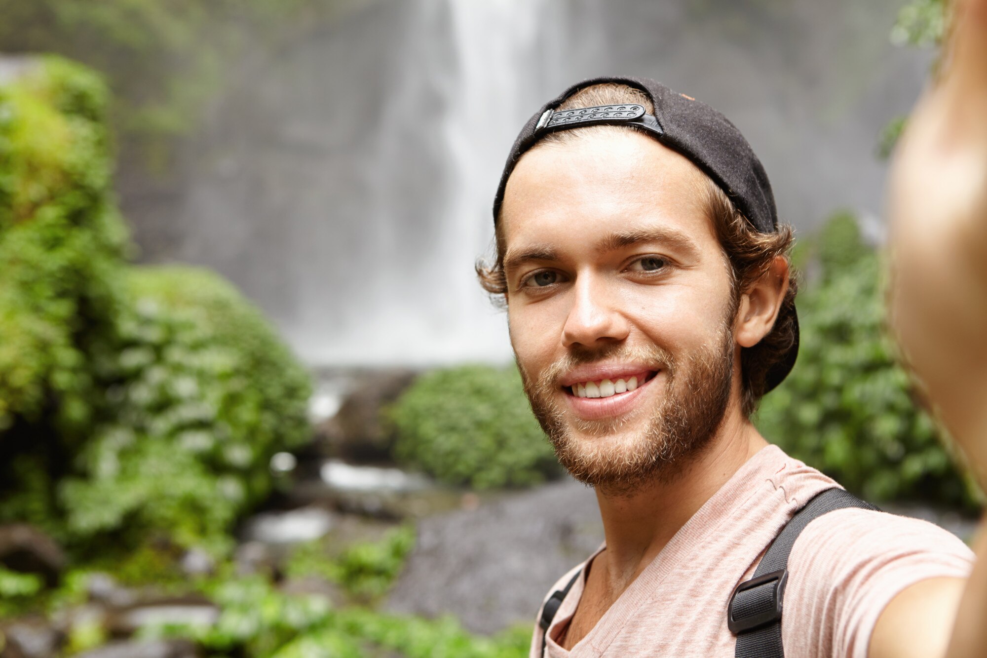 self portrait happy hiker baseball cap taking selfie while standing against waterfall green exotic woods young tourist trekking rainforest during his holidays 273609 1607