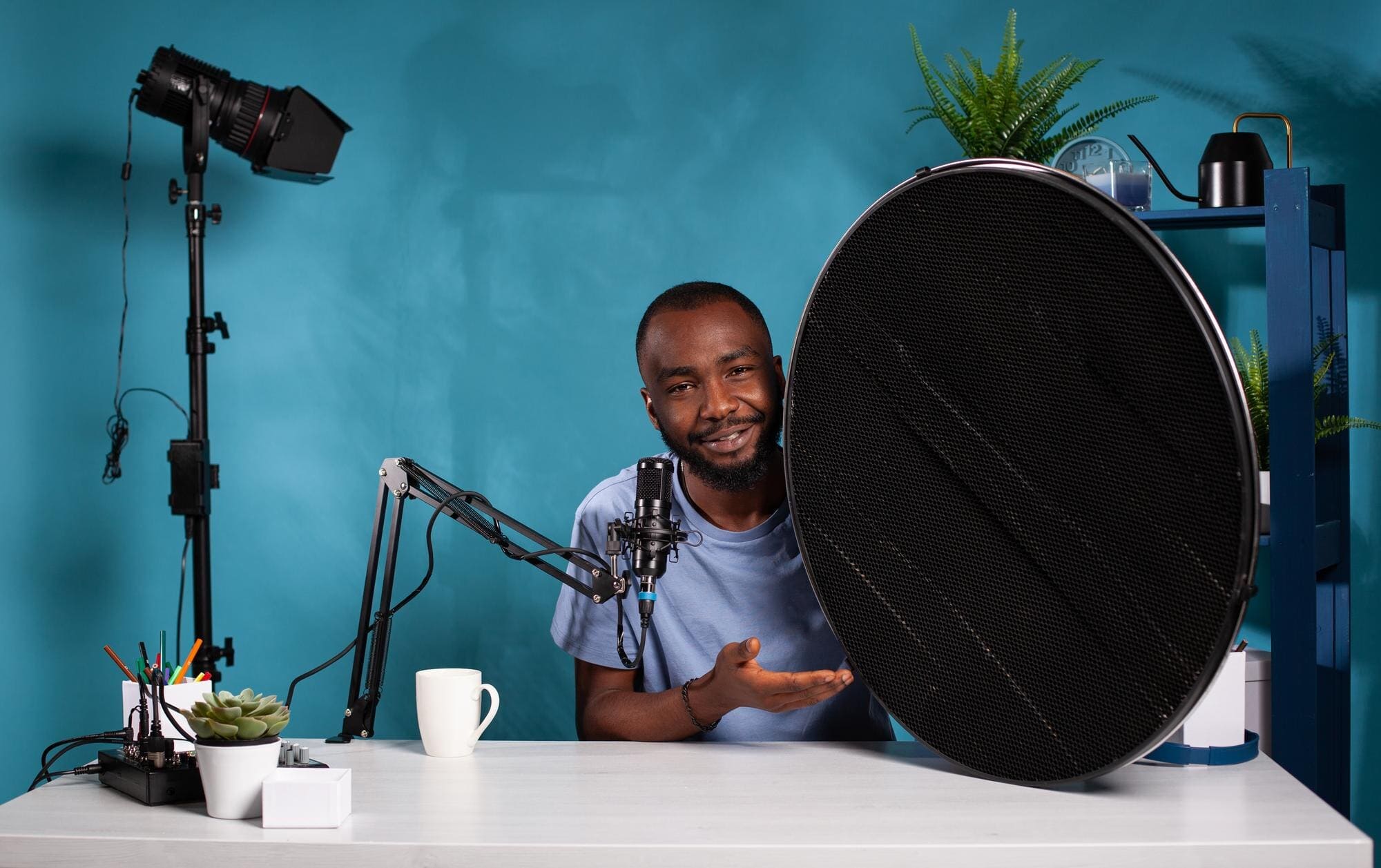 vlogger explaining features studio flash light modifier sitting desk with microphone vlogging studio portrait photography equipment reviewer presenting beauty dish honeycomb grid 482257 42668 1