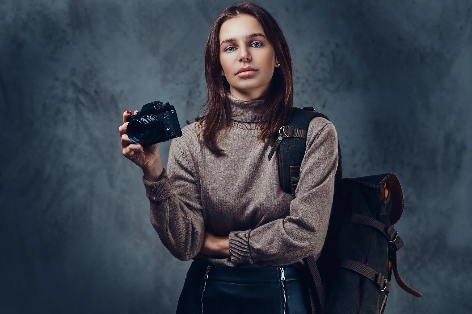 brunette female traveler with backpack holds compact photo camera 613910 15611