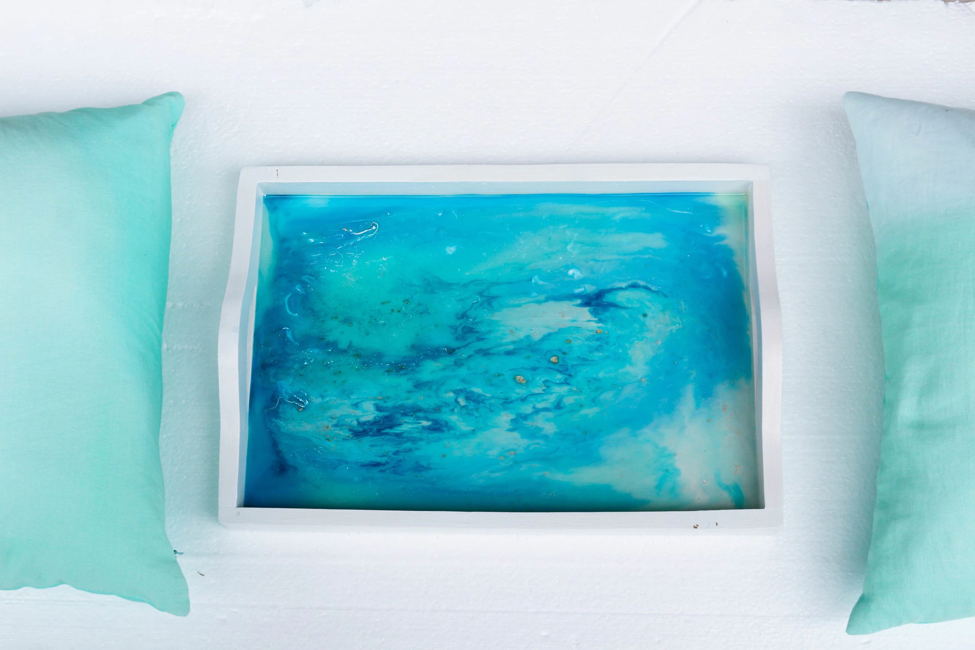 high angle closeup shot white tray with epoxy resin art with blue alcohol inks 181624 37508