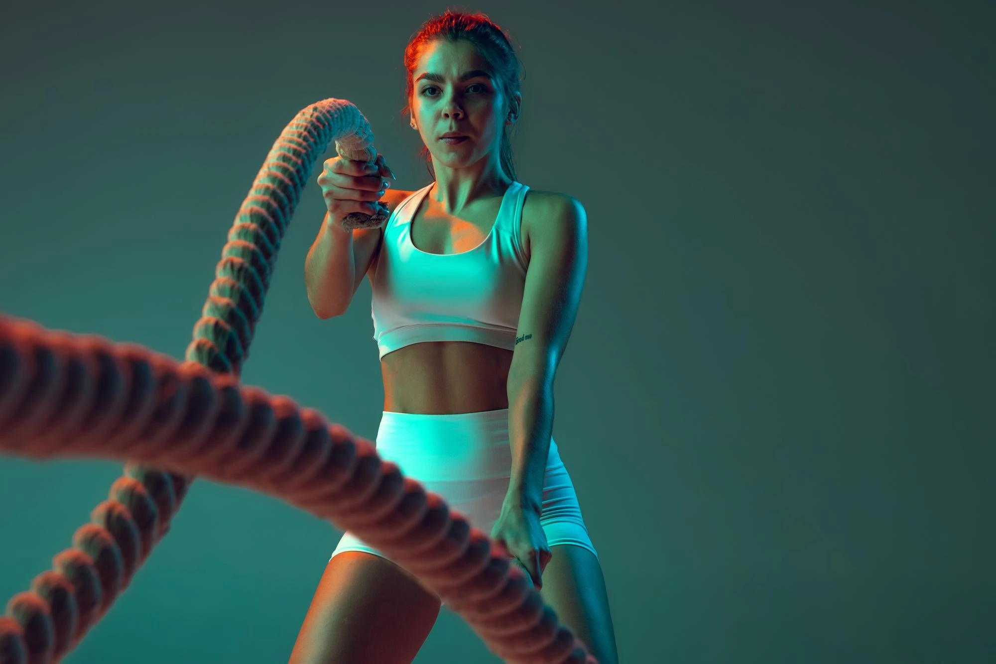 portrait young spotive girl doing exercises with rope keeping body fit isolated green background neon 155003 45635