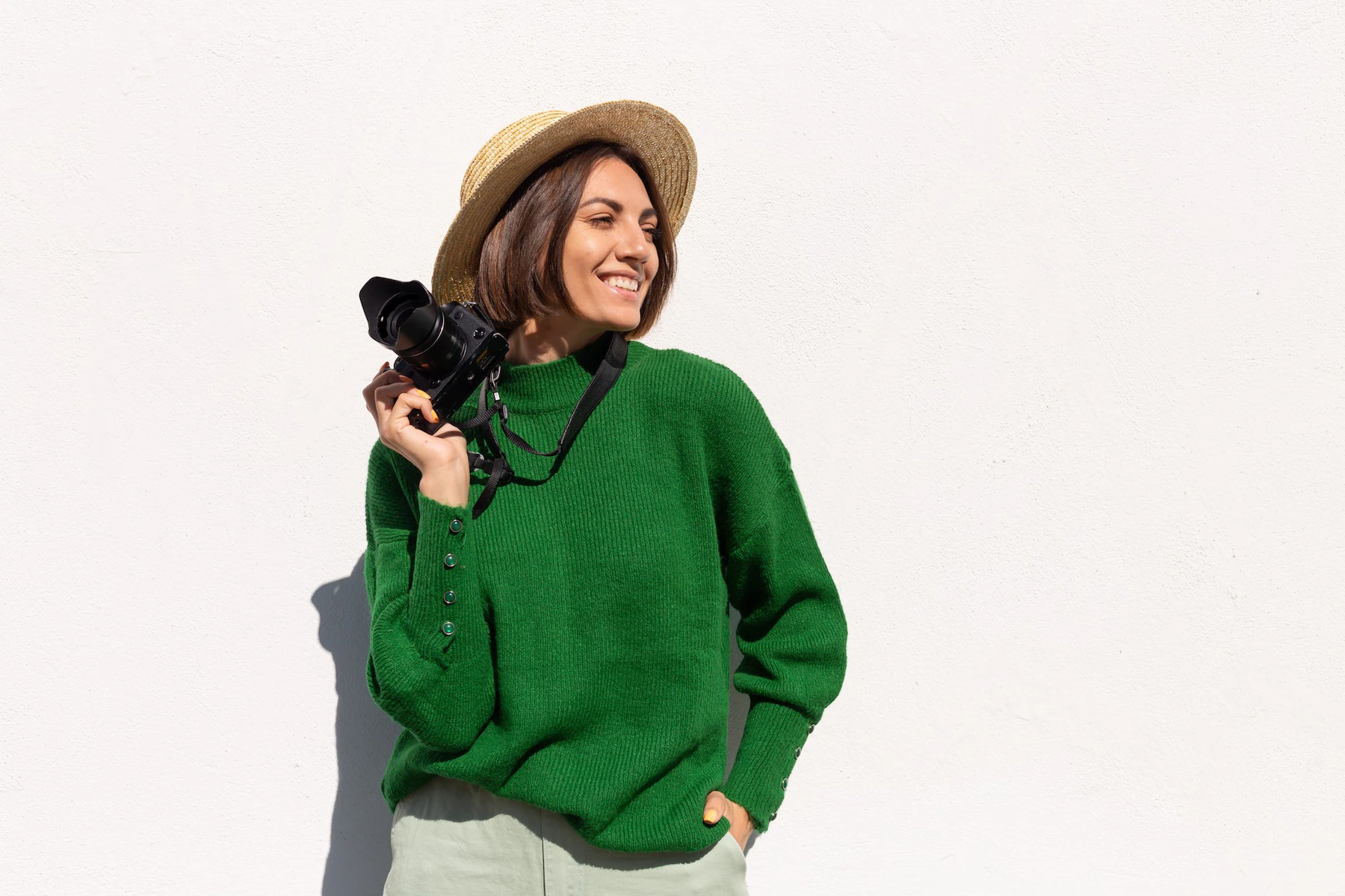 woman green casual sweater hat outdoor white wall happy positive tourist with professional camera 343596 6223