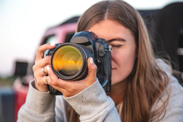 young woman with professional camera takes photo nature 169016 21743