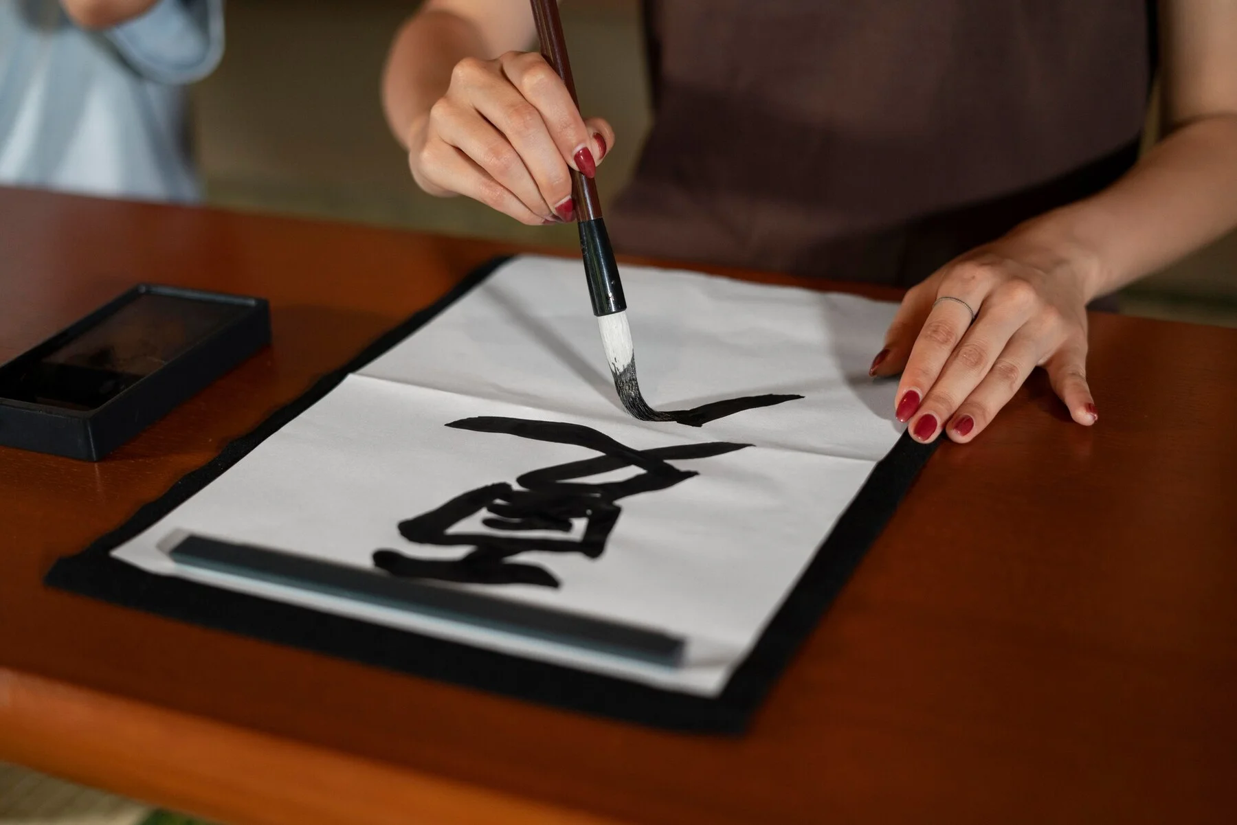 close up person doing japanese calligraphy called shodo 23 2149105328