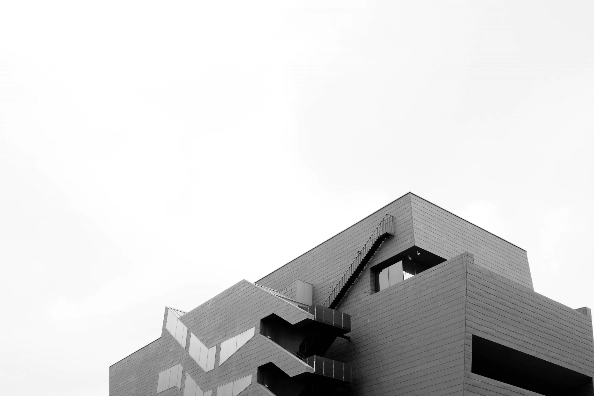 low angle greyscale shot concrete modern building isolated white wall 181624 6698 1